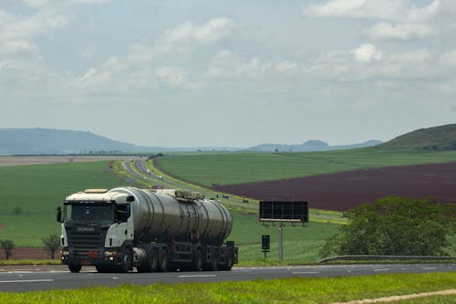 Free Truck Driving through Countryside under Blue Sky Stock Photo