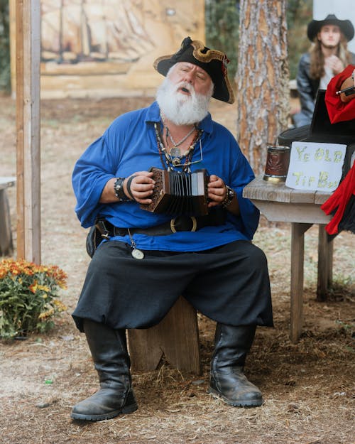 Man Dressed in Pirate Costume Playing Concertina