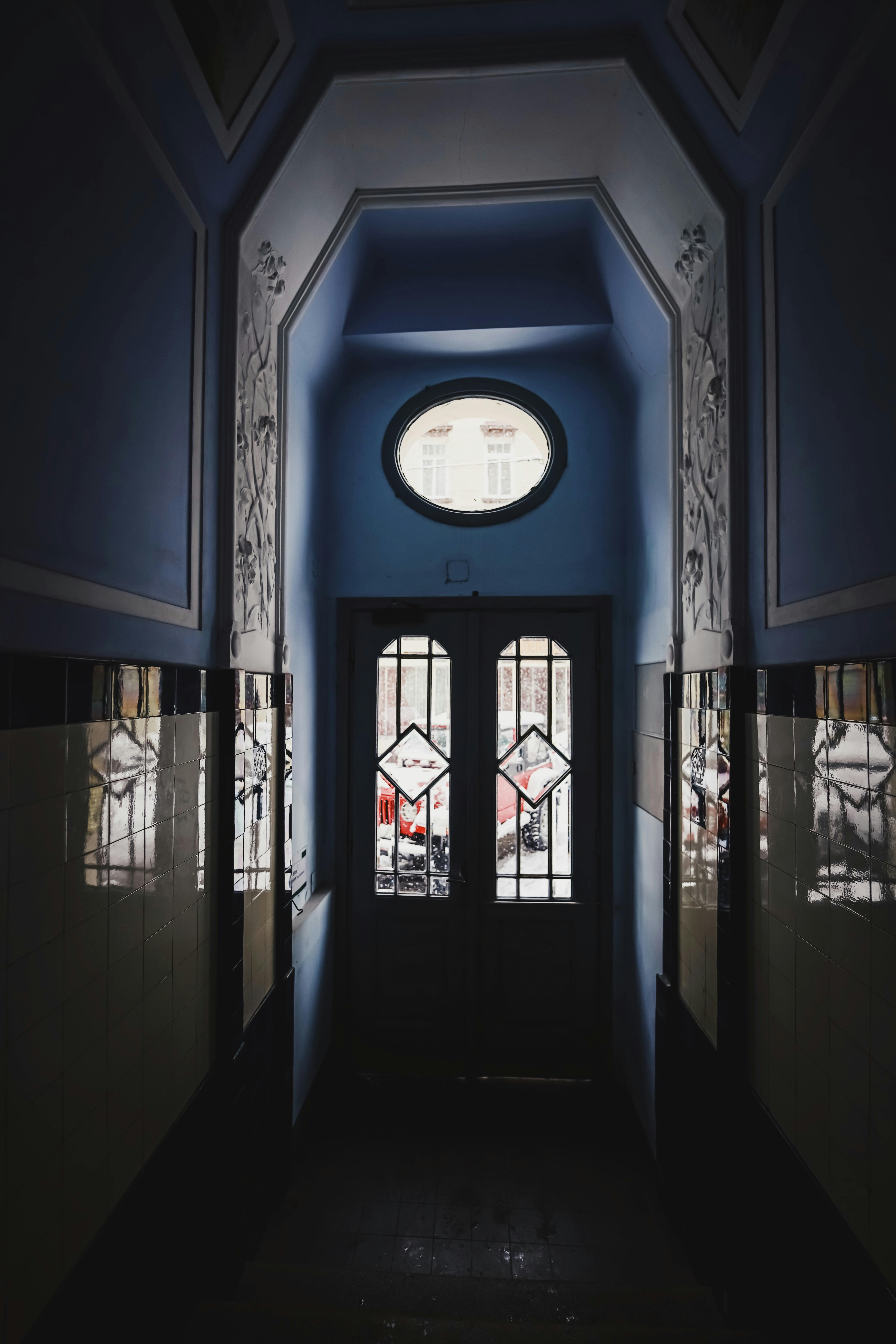 Ornate house doorway in a narrow passage with soft lighting. Architectural elegance captured beautifully.