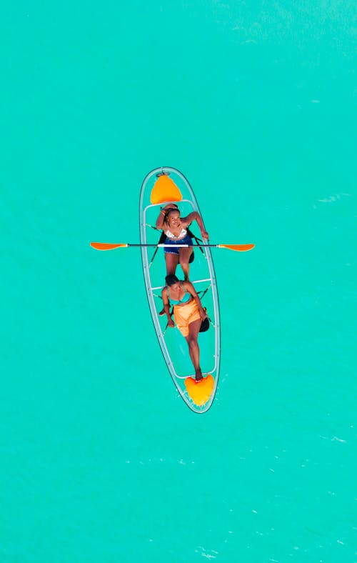 Women Canoeing on Turquoise Water