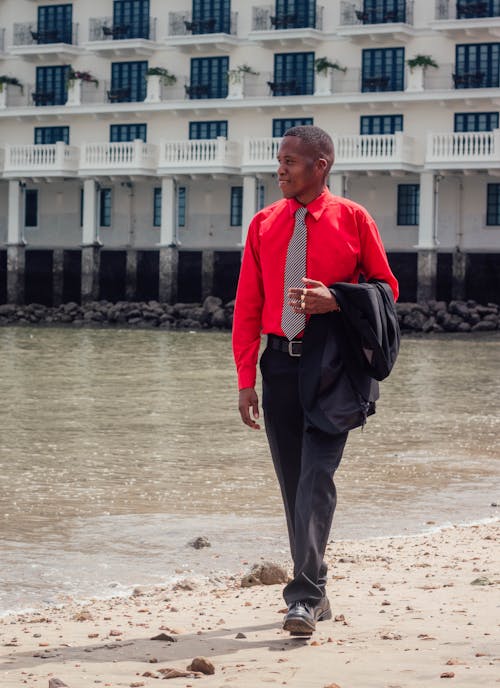 Elegant African Man Walking by the Shore 