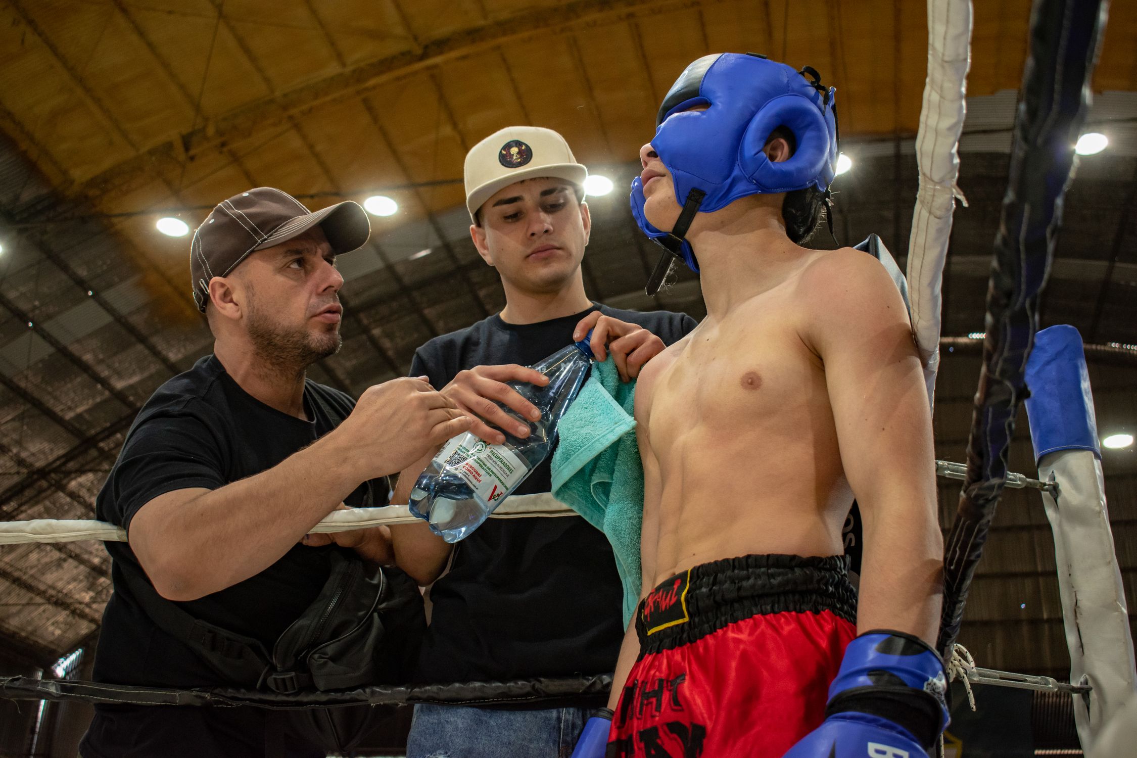 Boxer and His Trainers on a Championship · Free Stock Photo