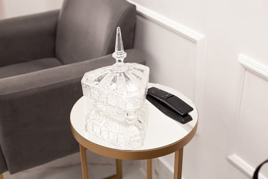 Elegant crystal bottle placed on a modern coffee table in a stylish living room interior.