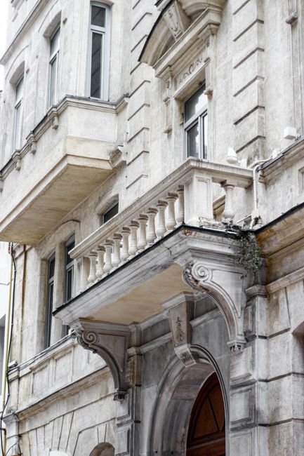 Close-up of a historical building's ornate facade with balconies and intricate carvings.