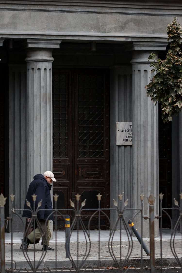 Elderly Hunched Man Walking In Passing By Galata Greek School In Istanbul