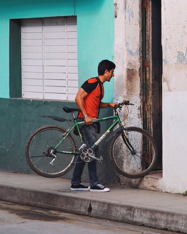 Man Entering Building With Bicycle