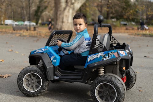 Free Little Boy Sitting in Electric Car Stock Photo