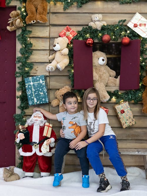 Children Posing in Front of Christmas Decoration