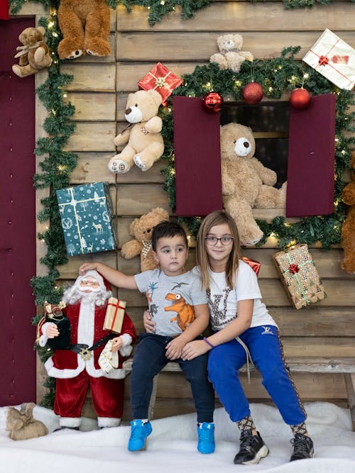 Children Posing in Front of Christmas Decoration 