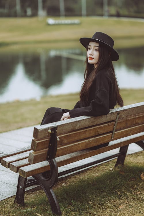 Portrait of Woman Wearing Hat Sitting on Bench