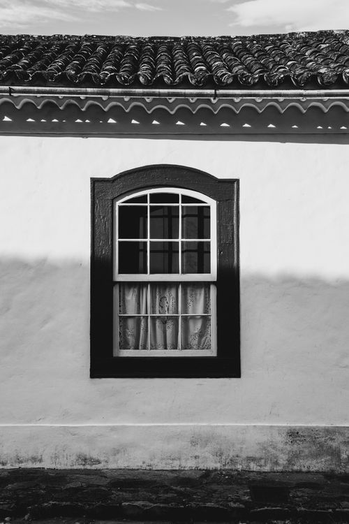 Free Elegantly captured black and white photo showcasing a traditional house window. Stock Photo