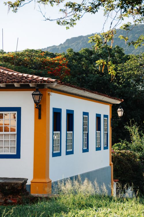 Free Beautiful colonial-style house corner surrounded by lush trees in Tiradentes, Brazil. Stock Photo