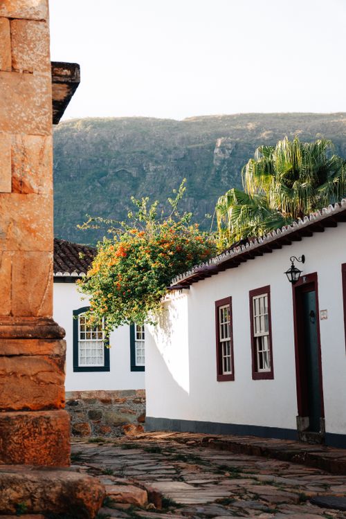 Free Sunlit colonial architecture with mountains in Tiradentes, Minas Gerais, Brazil. Stock Photo