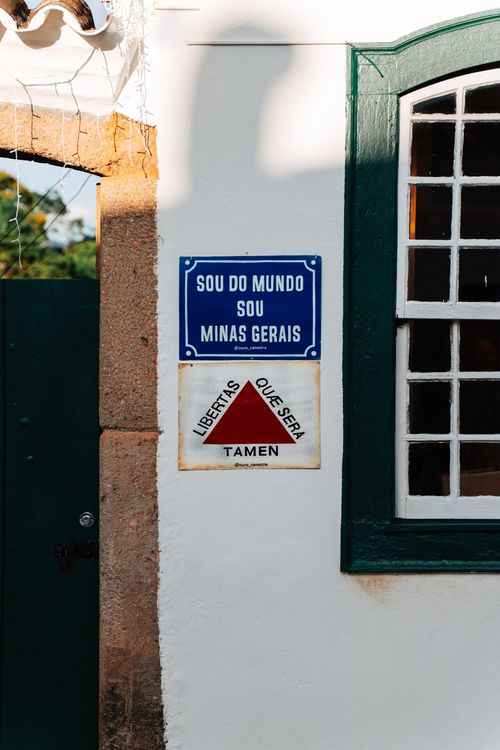 Free Colorful signs on a historic wall in Tiradentes, Minas Gerais, capturing Brazilian culture and architecture. Stock Photo