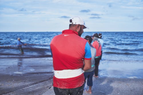 Back View of Fishermen on Sea Shore