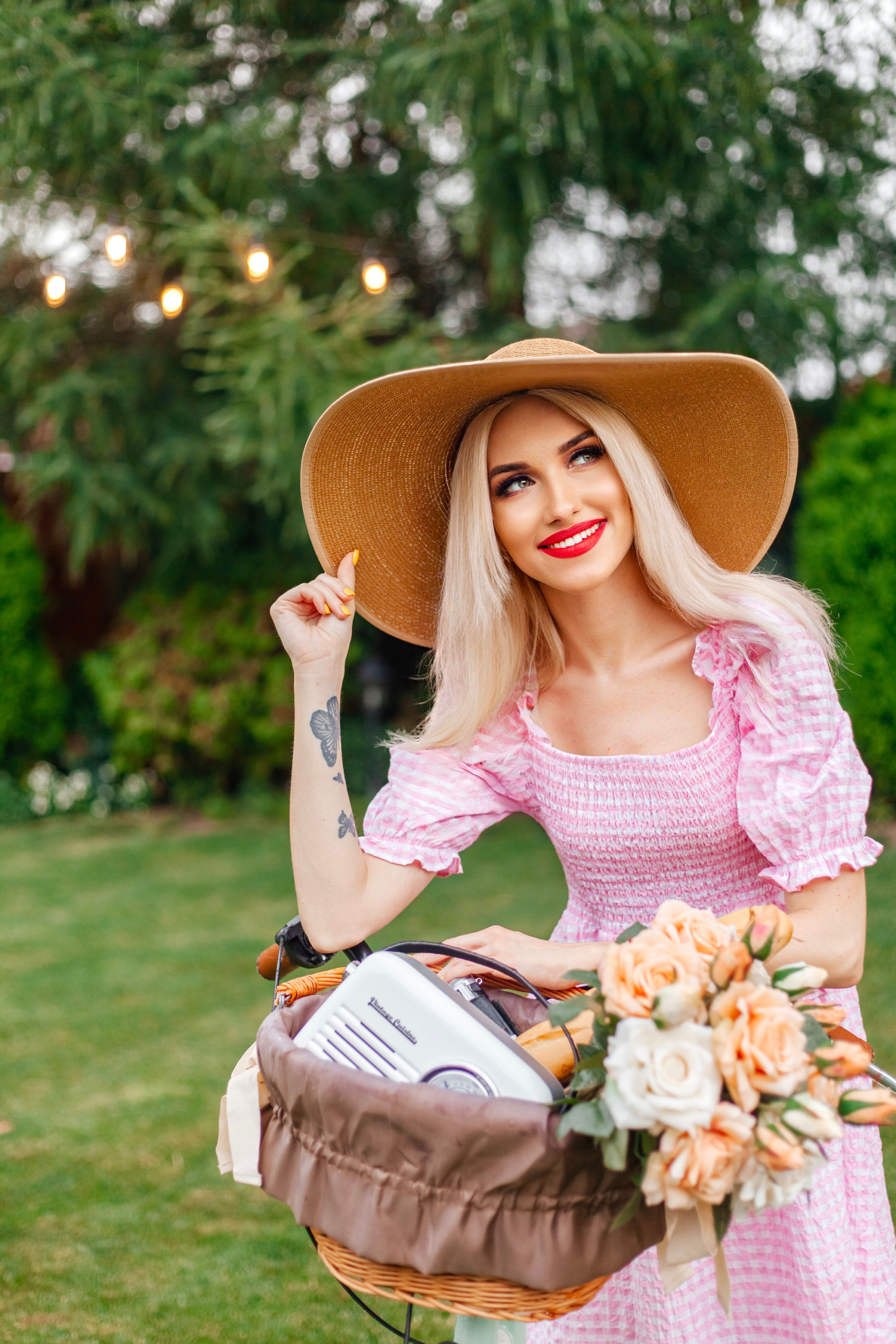 A blonde woman in a pink dress holding a basket of flowers · Free Stock ...