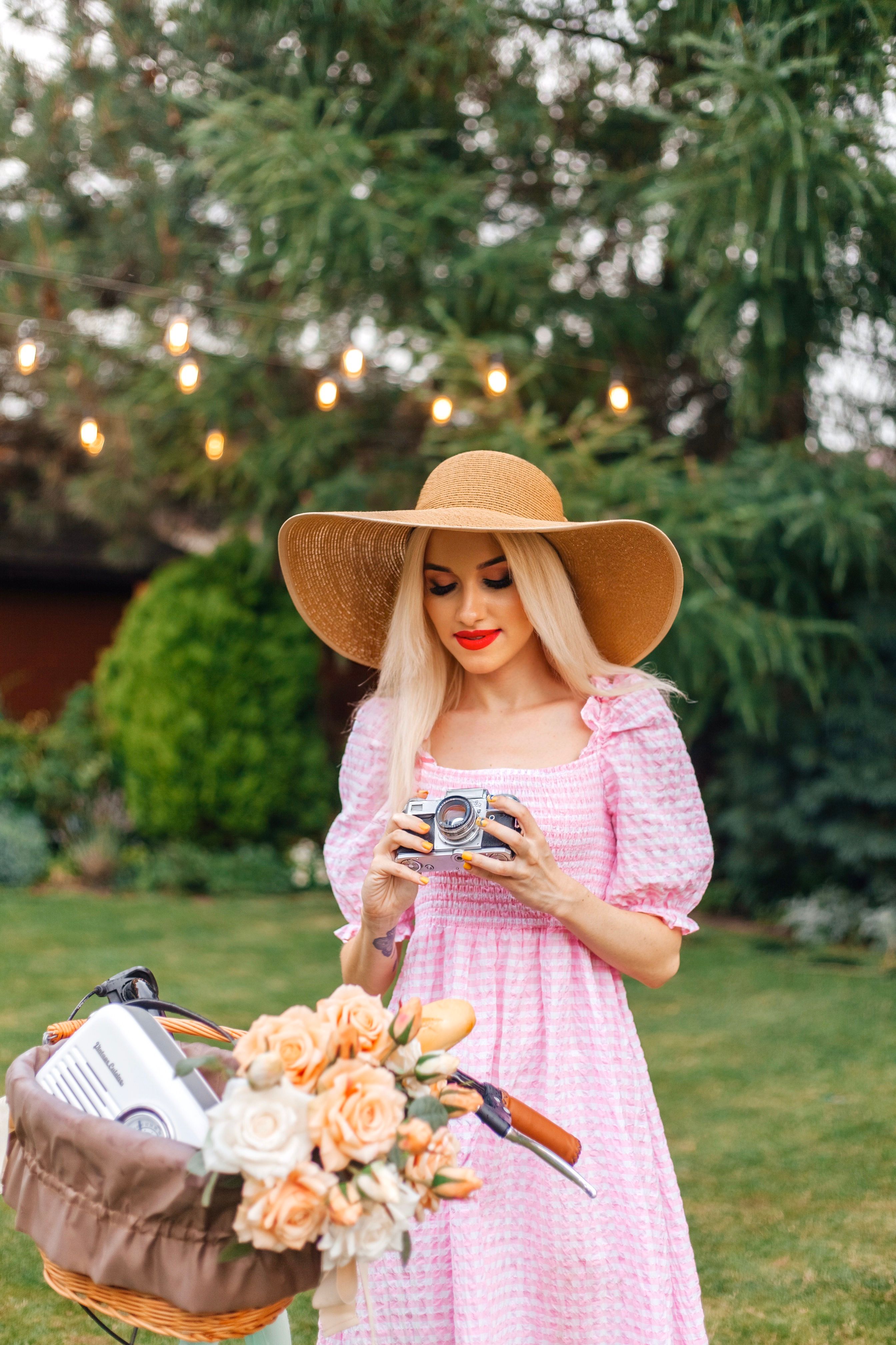 A woman in a pink dress holding a basket of flowers · Free Stock Photo