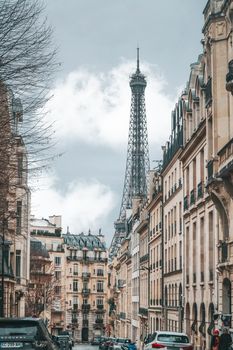 Quaint Parisian street with the Eiffel Tower in the background, showcasing iconic architecture.
