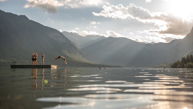 Man Jumping Into A Lake From A Floating Platform