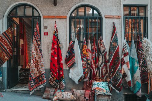 Free A vibrant display of traditional Turkish carpets hanging in an Istanbul street market. Stock Photo