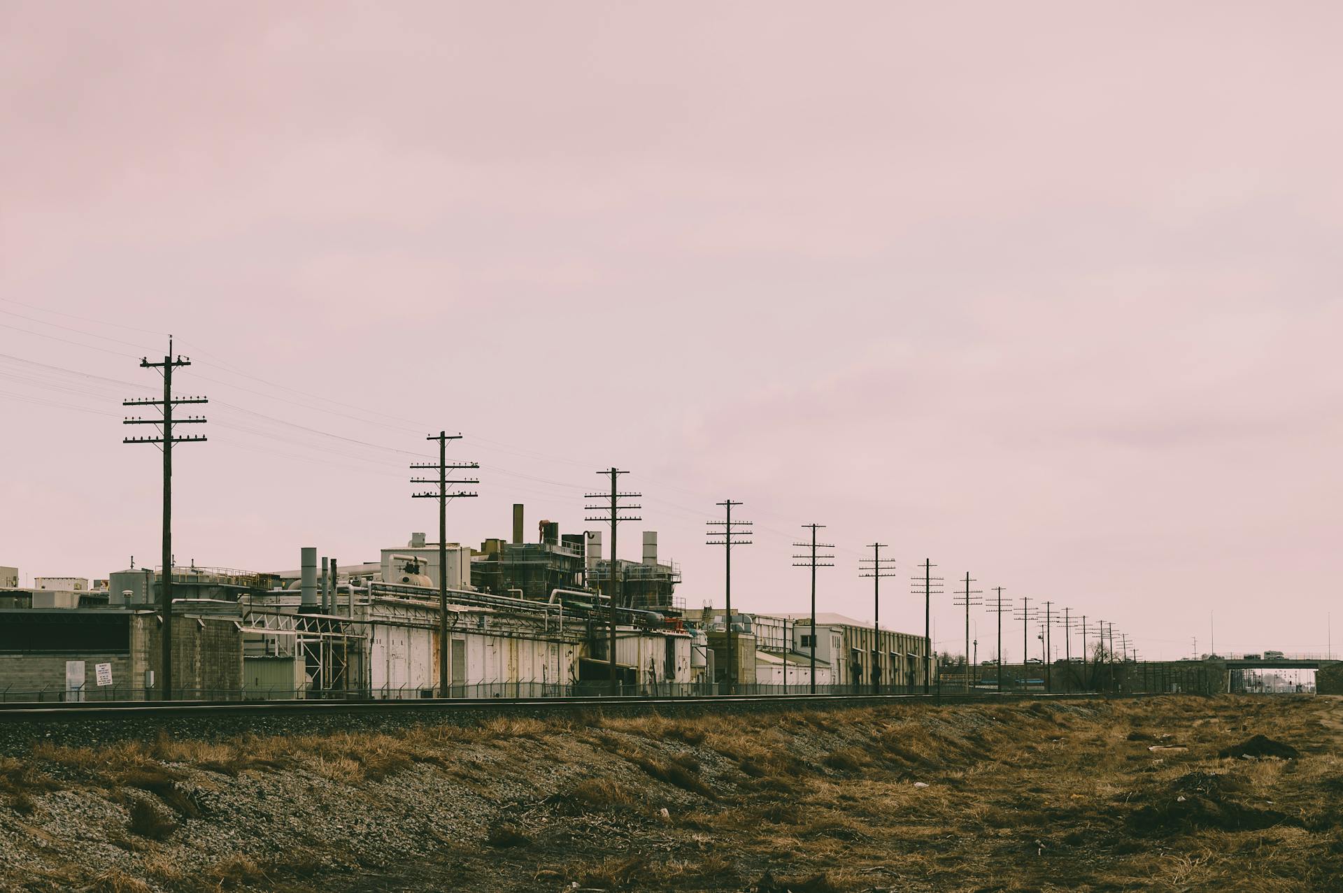 Line of Electric Post Near Concrete Building