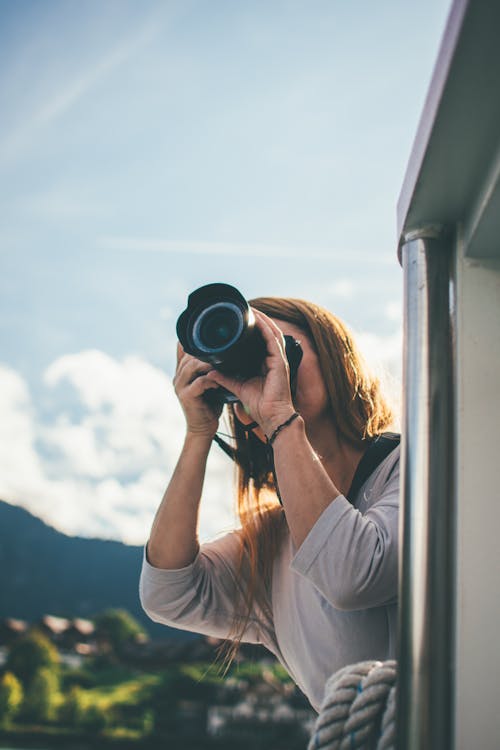 A woman taking a photo with a camera