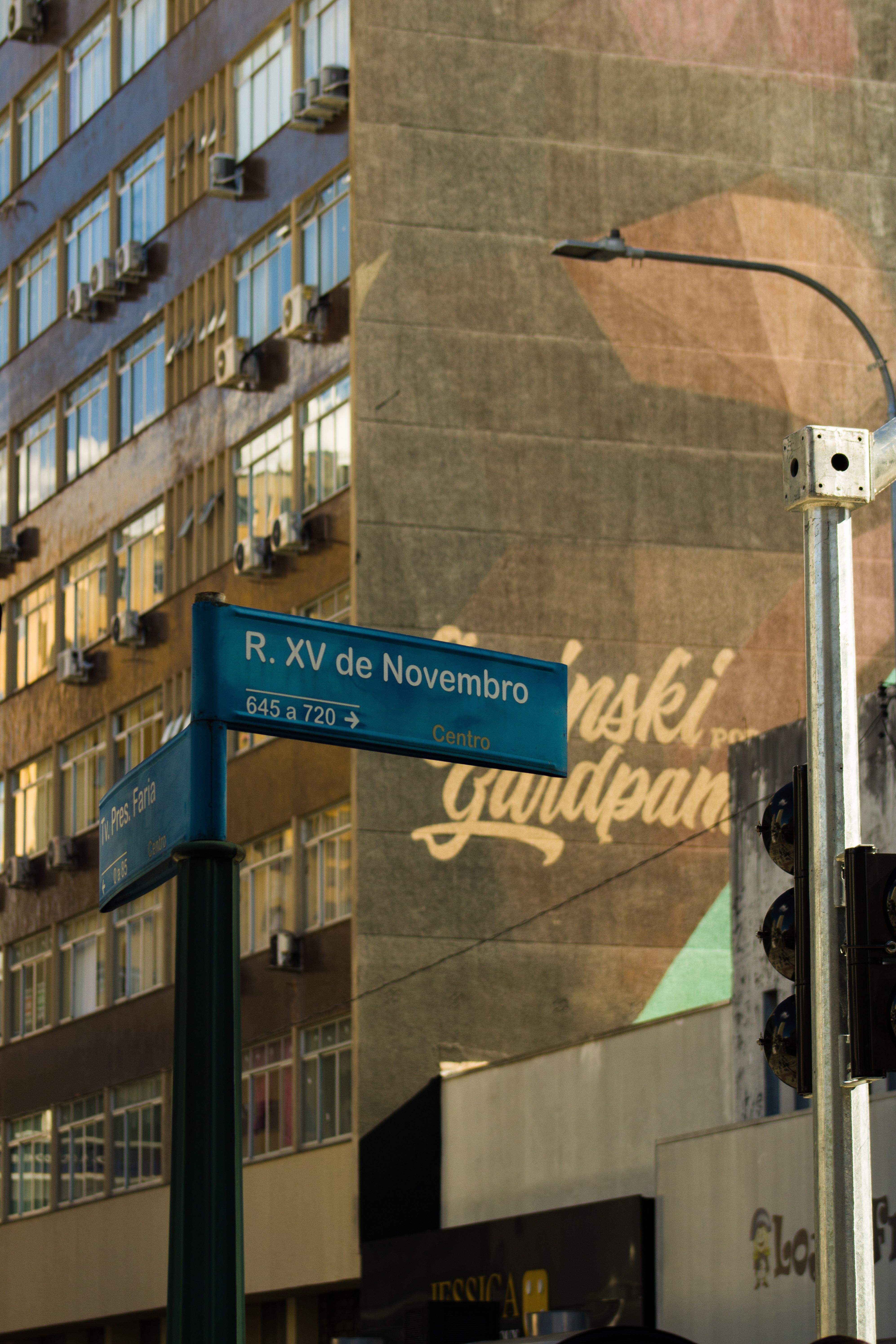 View of Rua XV de Novembro street sign in Curitiba with nearby building.