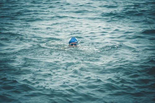 Free Person Swimming on Sea Stock Photo