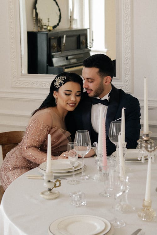 Smiling Newlyweds Sitting by Table