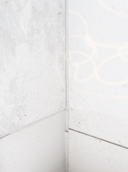 A textured white corner wall with subtle patterns, ideal for backgrounds.