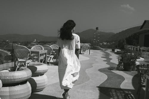Back View of Woman Walking in White Sundress
