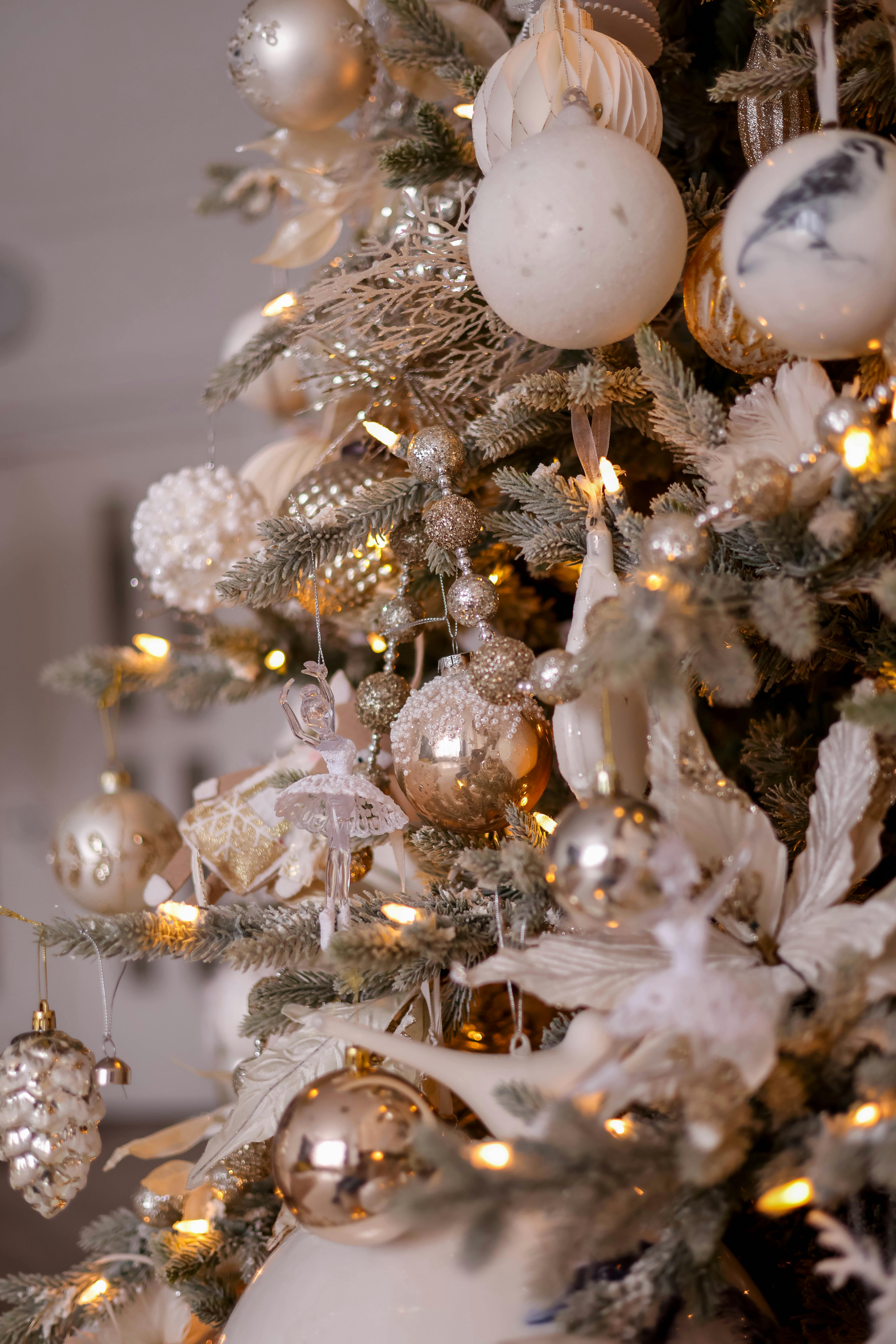 Upscale Christmas tree adorned with elegant ornaments in warm lighting.