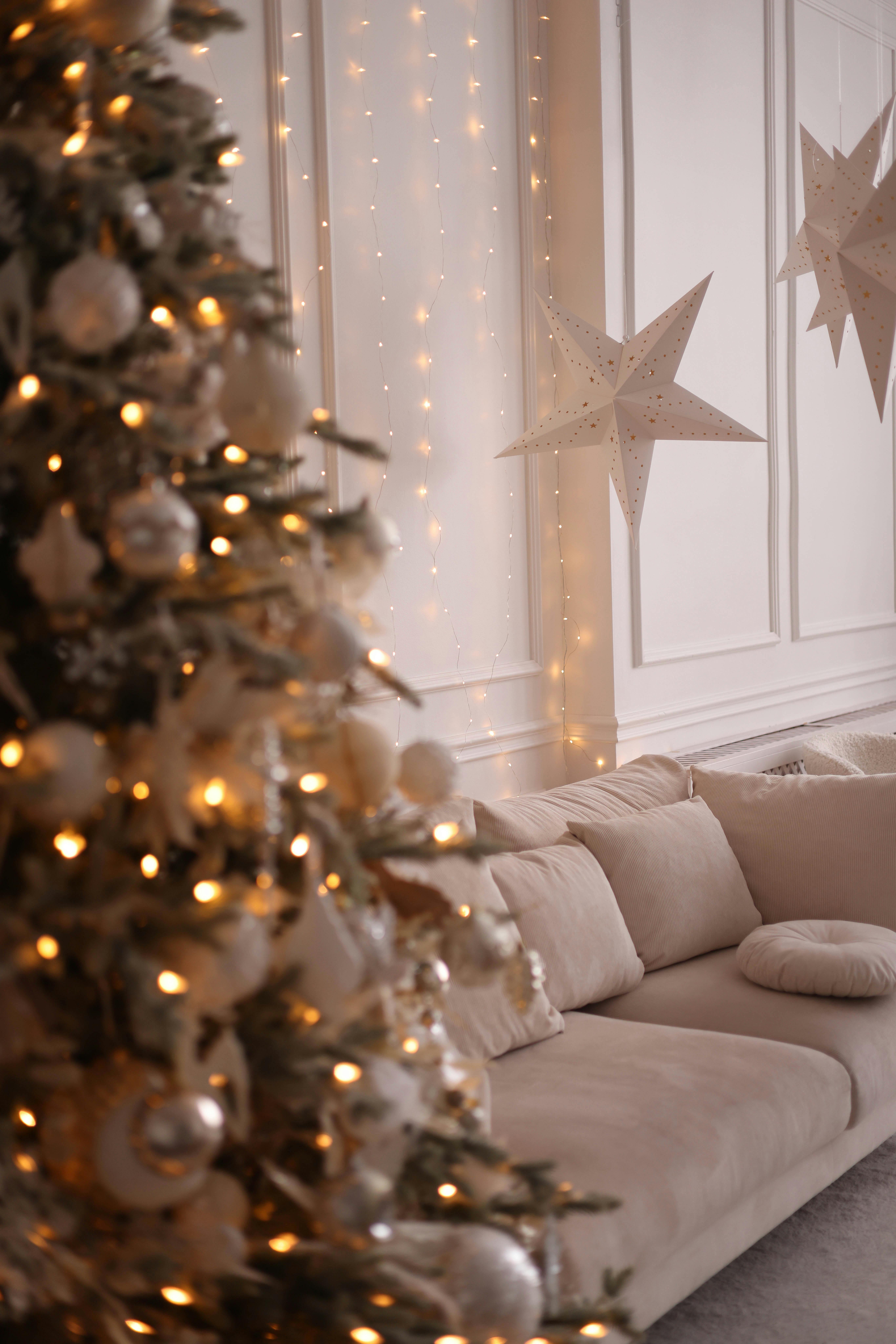 Free Warm and inviting living room decorated with a Christmas tree, lights, and stars. Stock Photo