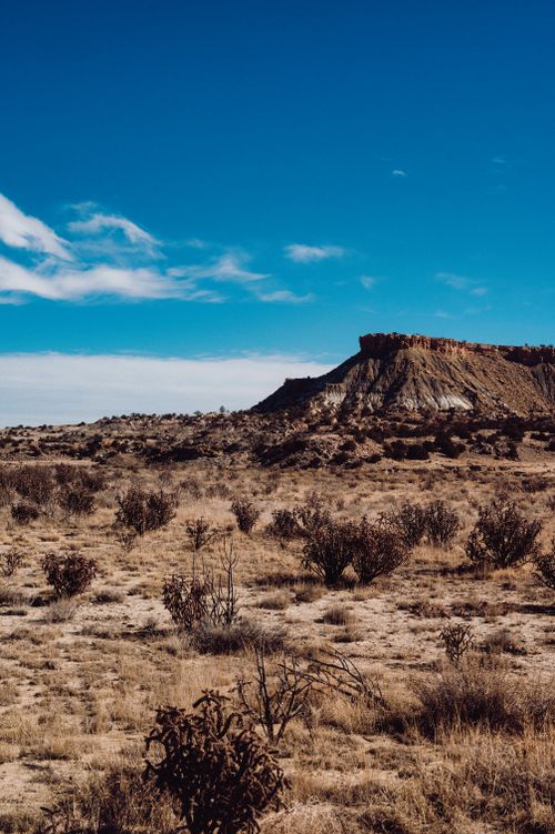 Free Explore a breathtaking arid desert plateau under a clear blue sky, capturing the beauty of natural formations. Stock Photo