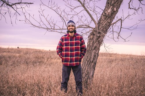 Smiling Man in Shirt Standing by Tree