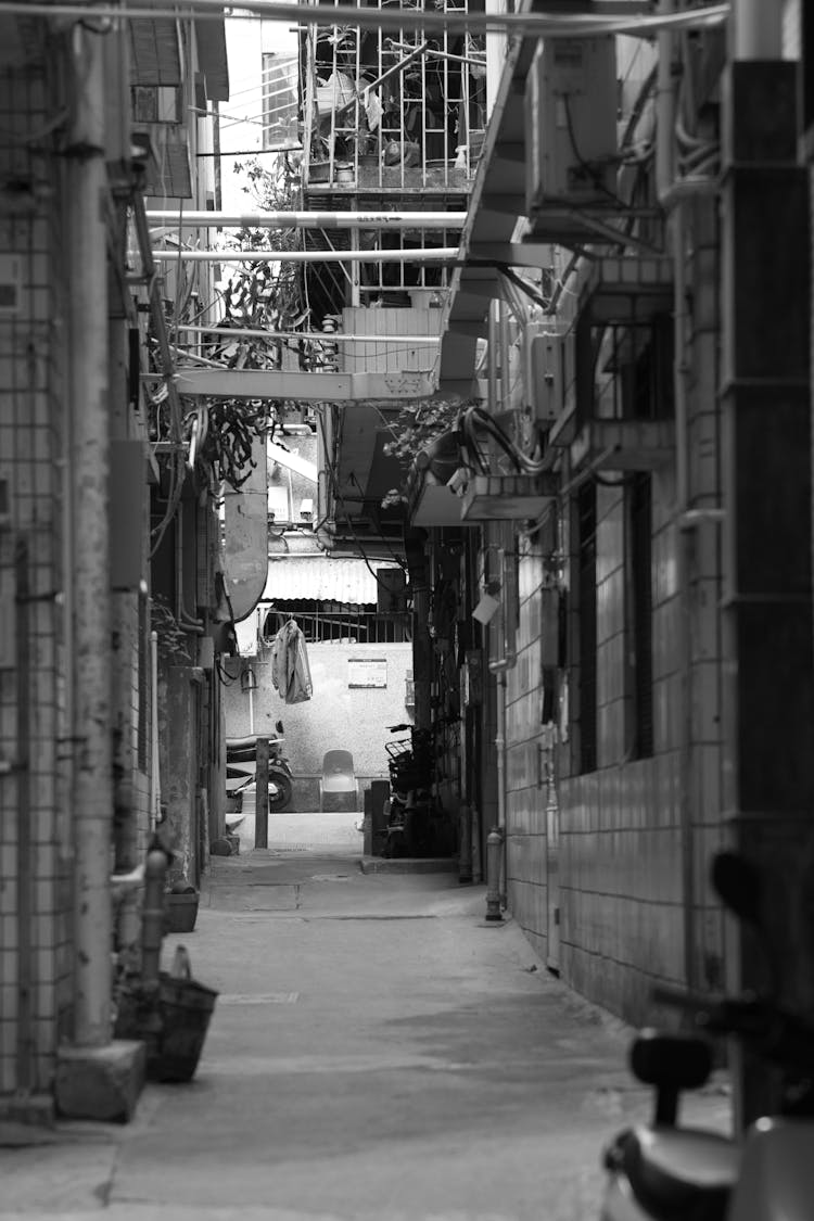 Black And White Photo Of A Passage In A City 