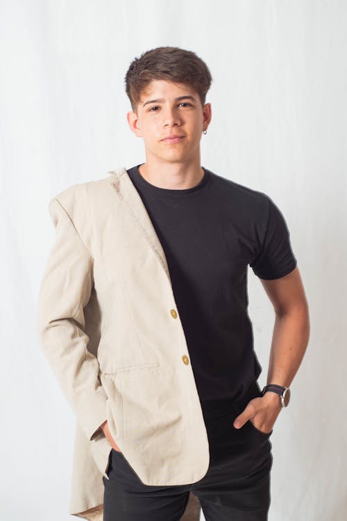 Young Man in a Fashionable Outfit Posing in Studio 