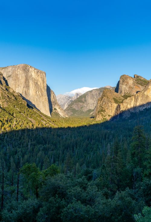 Free Breathtaking landscape of Yosemite Valley with El Capitan and Half Dome under a clear blue sky. Stock Photo