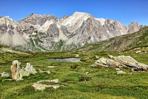 Free Scenic view of rocky mountains and lush grasslands in Briançon, France. Stock Photo