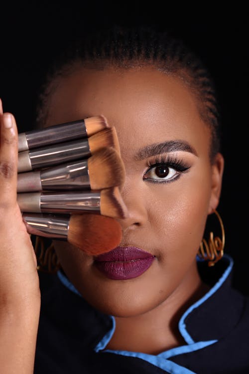 Close up of Woman Holding Makeup Brushes
