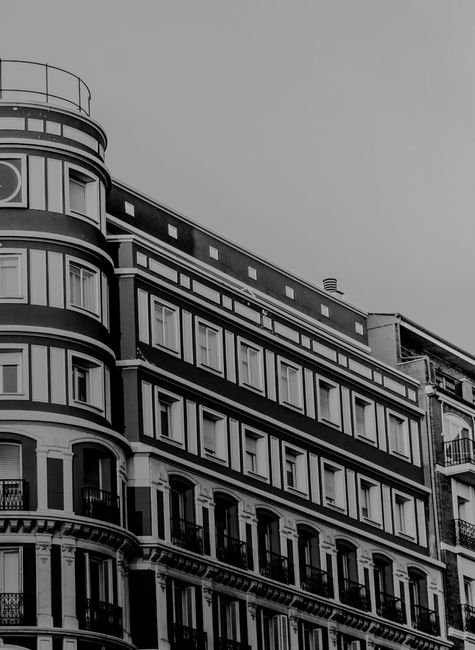 A modern building facade with classic architectural details in a city setting.