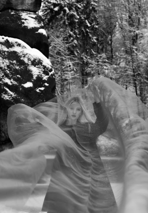 Woman under Veil in Forest in Winter in Black and White