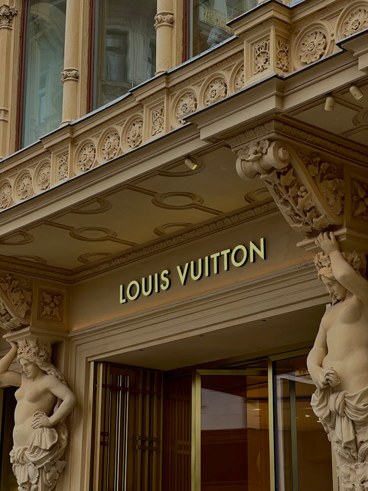 A Louis Vuitton Store On A Building With Carved Details 