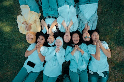 A Group of Girls Lying on the Grass and Smiling 