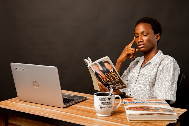 Young Man Sitting And Reading A Book 