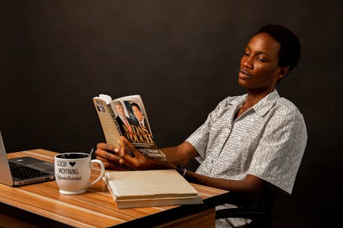 Free Young Man Sitting and Reading a Book  Stock Photo