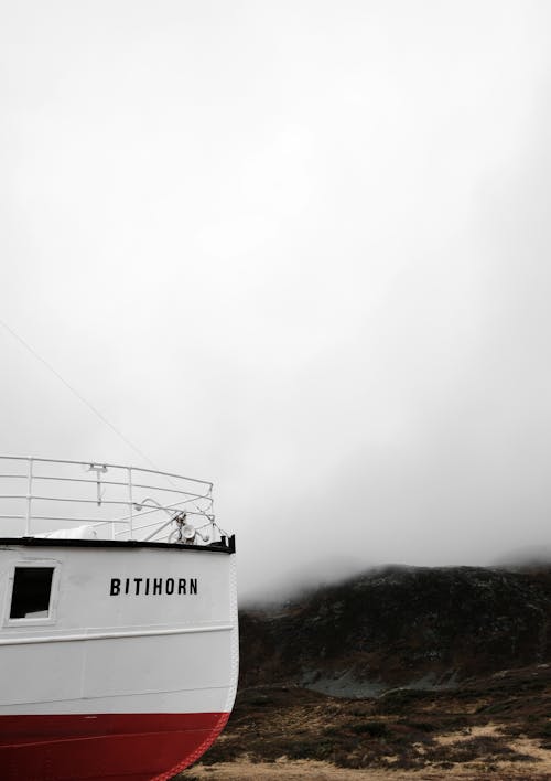 View of a Ship and Fog Covered Mountains in the Distance 