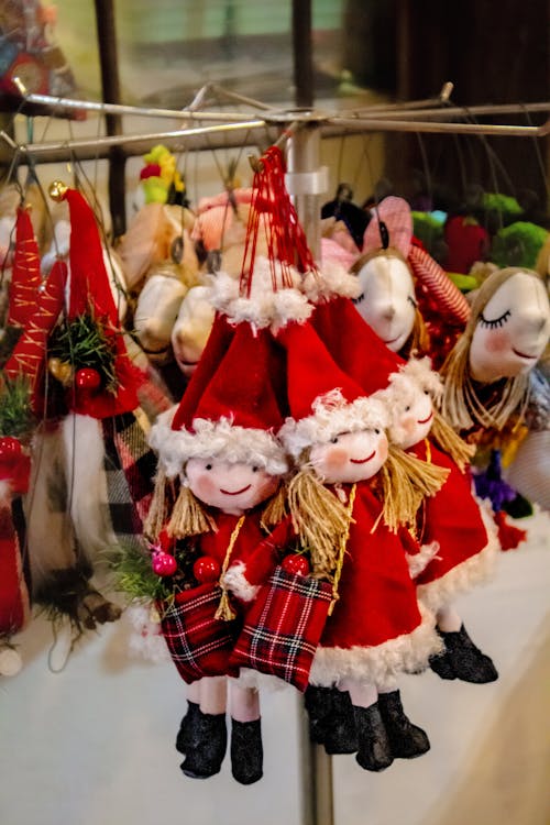 Dolls in Santa Costumes Hanging on a Rack 