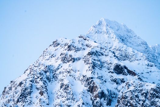 Beautiful snow-covered mountain peaks in Tromsø, capturing winter's pristine beauty.