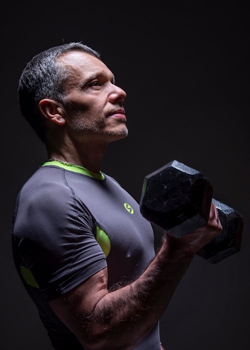 Free Muscular Man Holding a Dumbbell Stock Photo